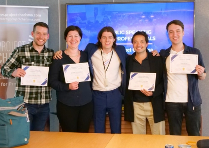 Group of professionals with Ed Darling holding certificates after completing the 1-Day Public Speaking Masterclass with Project Charisma