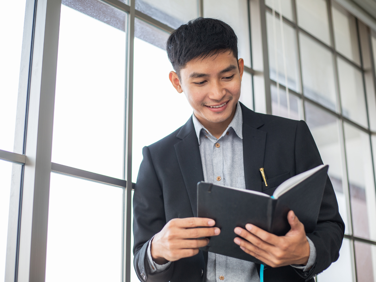 Man reading books on communication skills and public speaking