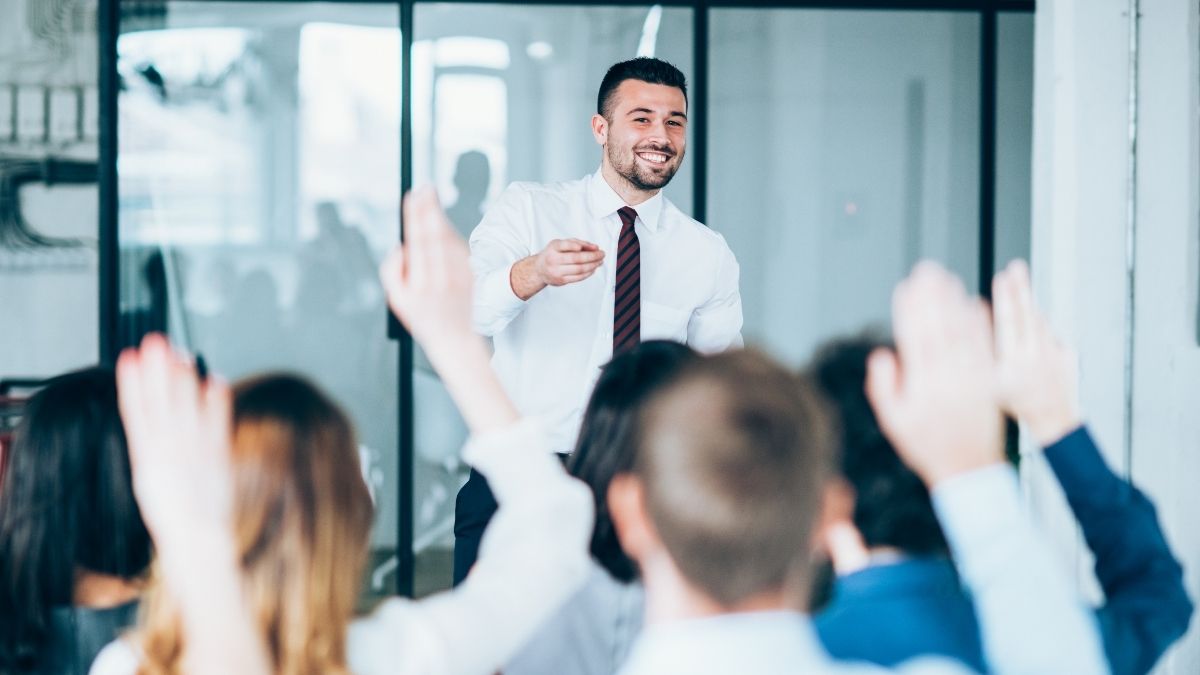 Professional man presenting to an audience during a public speaking training exercise.