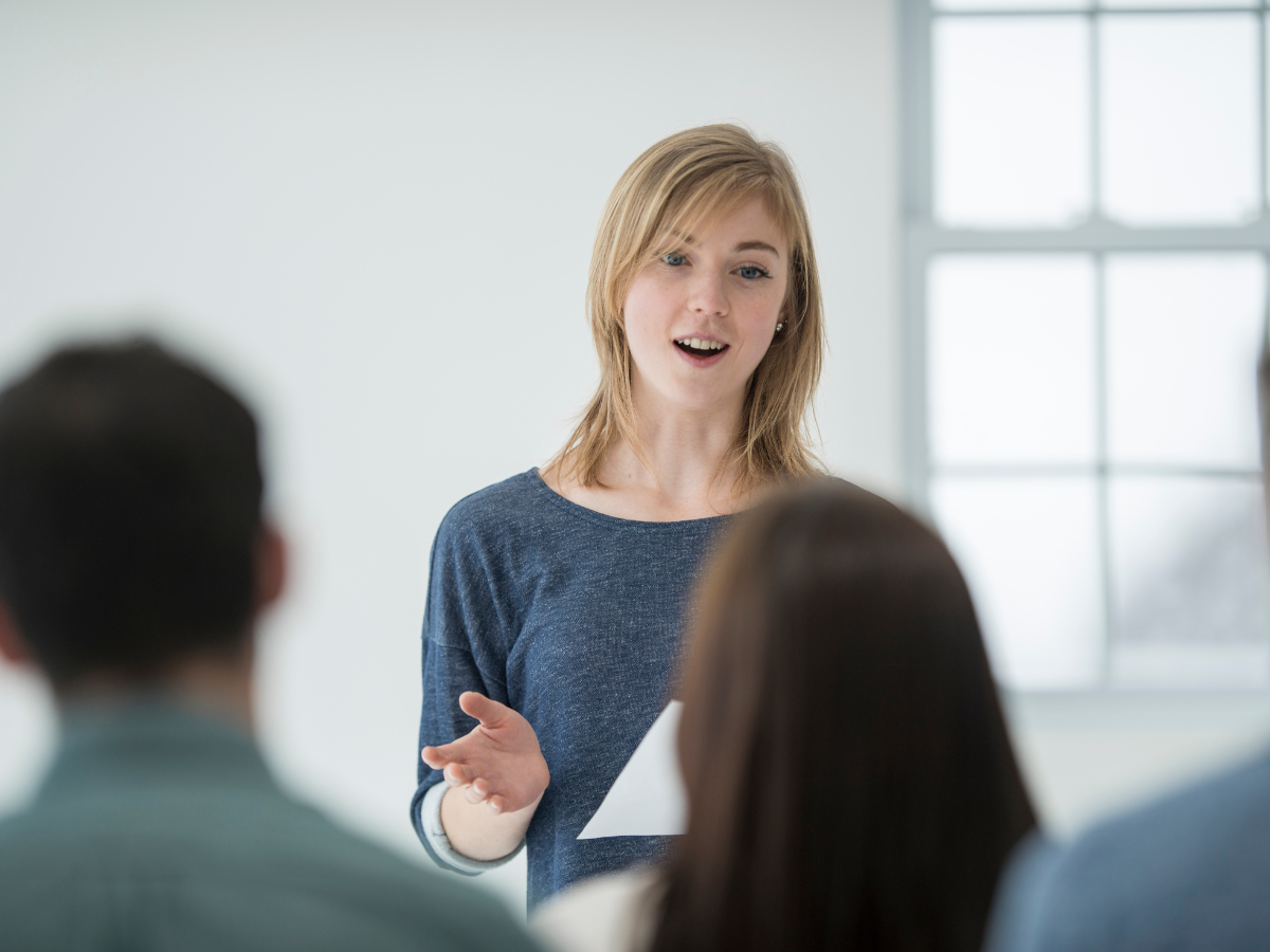 woman communicates with confidence in a meeting