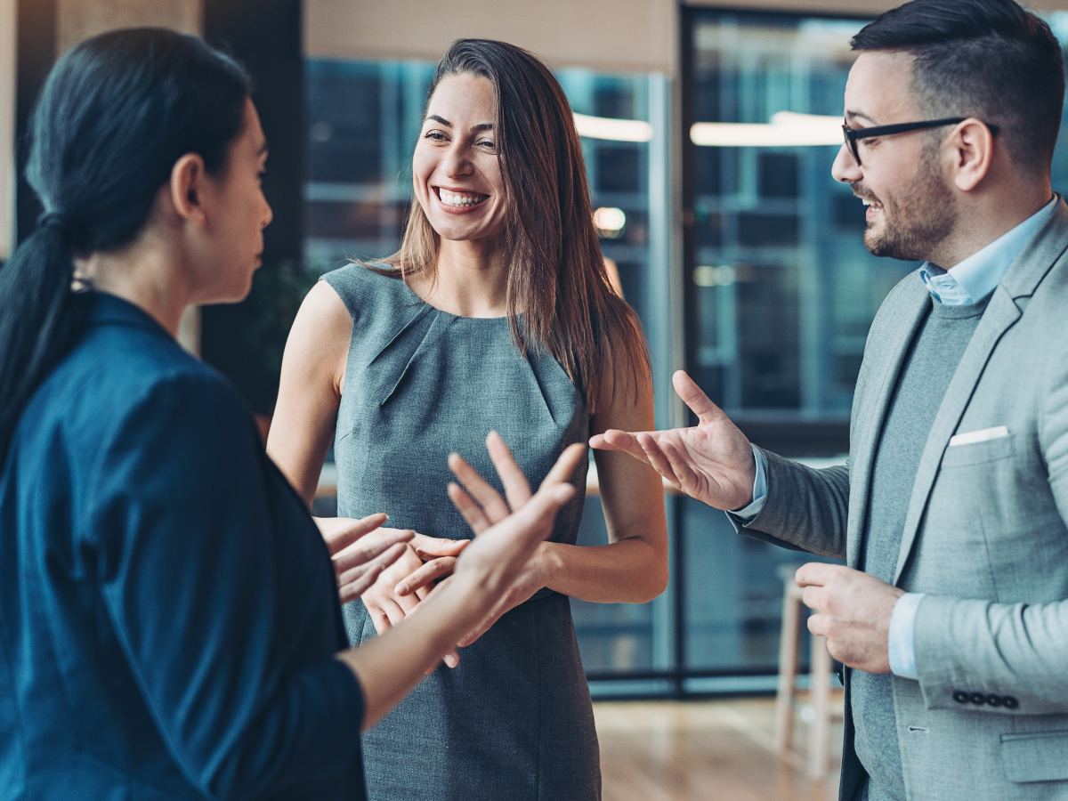 Professionals speaking at a business networking event.