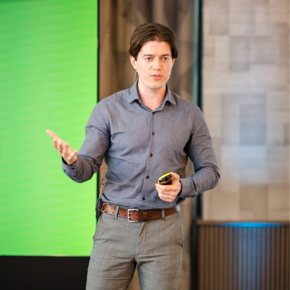 Ed Darling speaking on stage at a training event