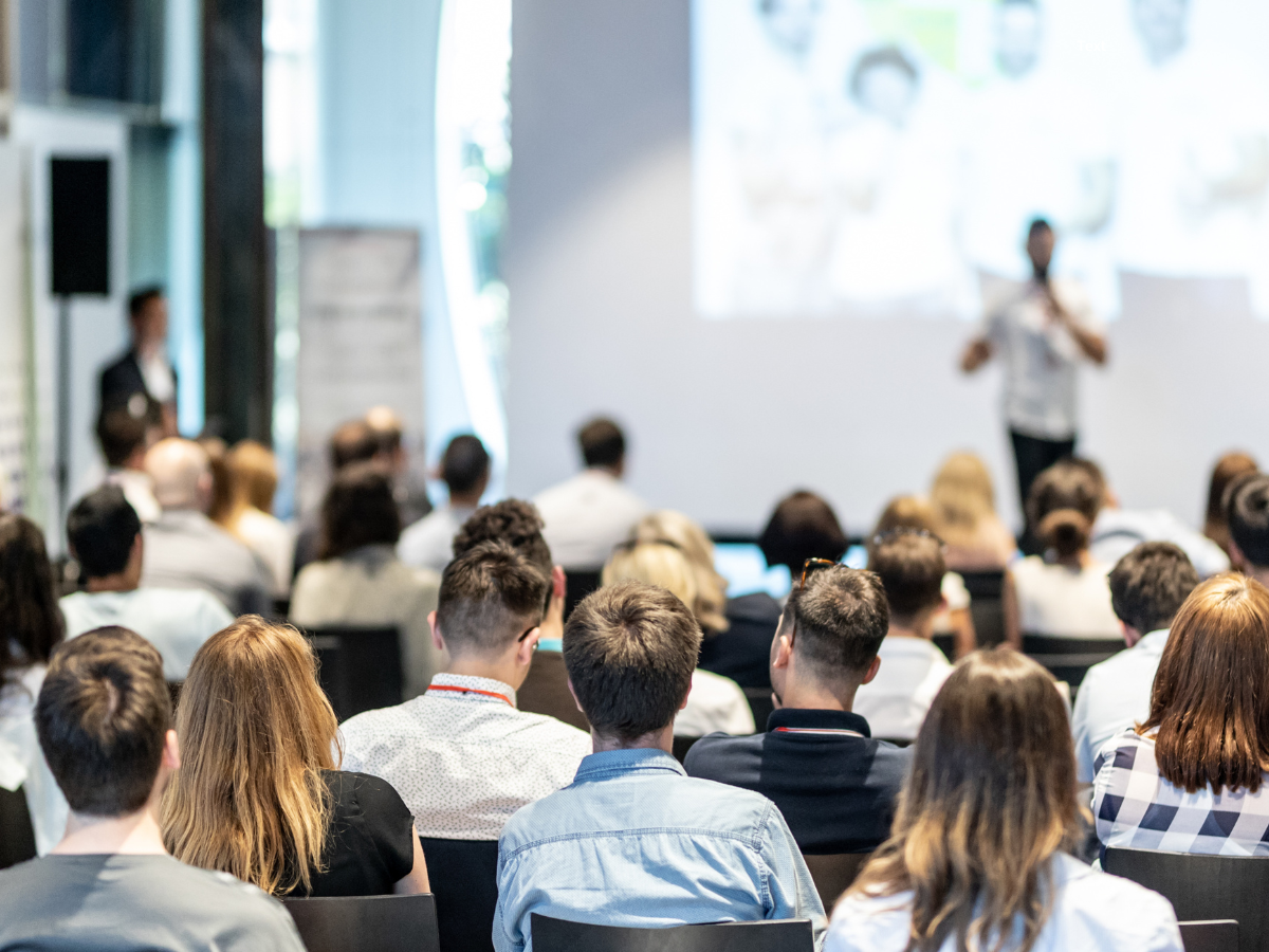 Man explaining how to become a paid speaker to audience.