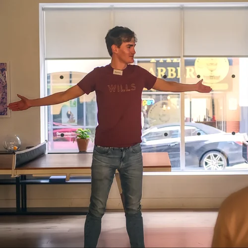 Man with arms wide delivering speech